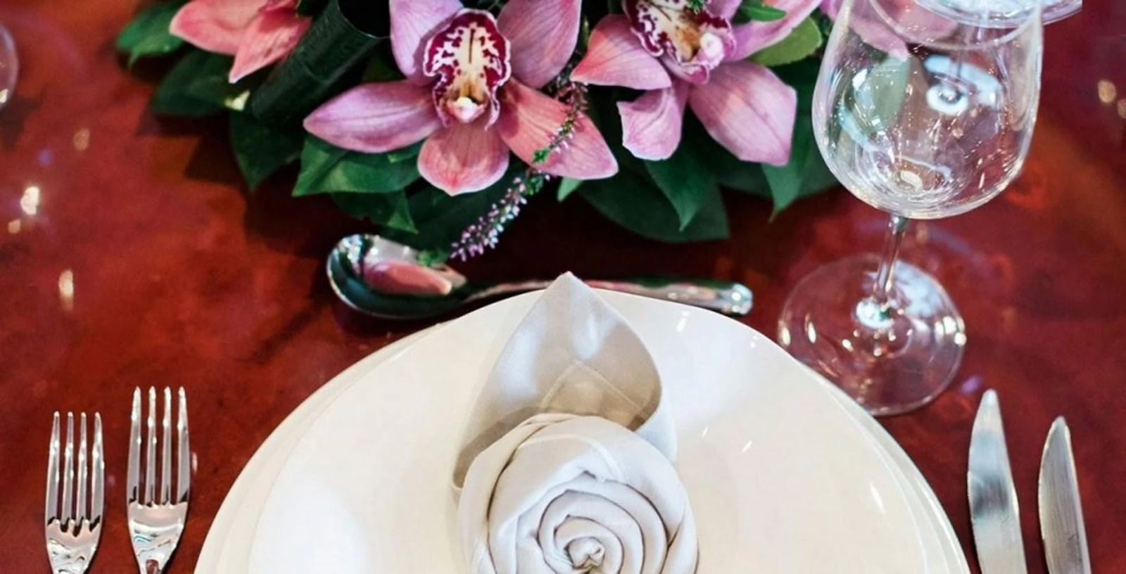 a plate with napkins and flowers on it aboard ALBATOR 2 Yacht for Sale