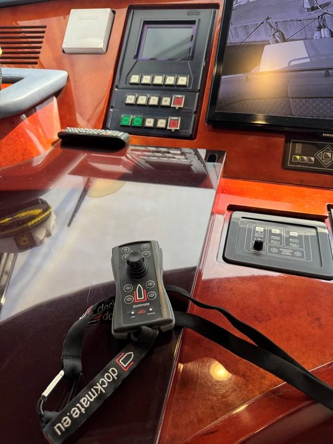 a table with a phone and a remote control on it aboard ALBATOR 2 Yacht for Sale
