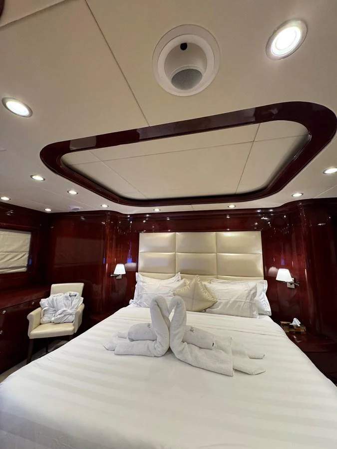 a bed with a white bed spread aboard ALBATOR 2 Yacht for Sale