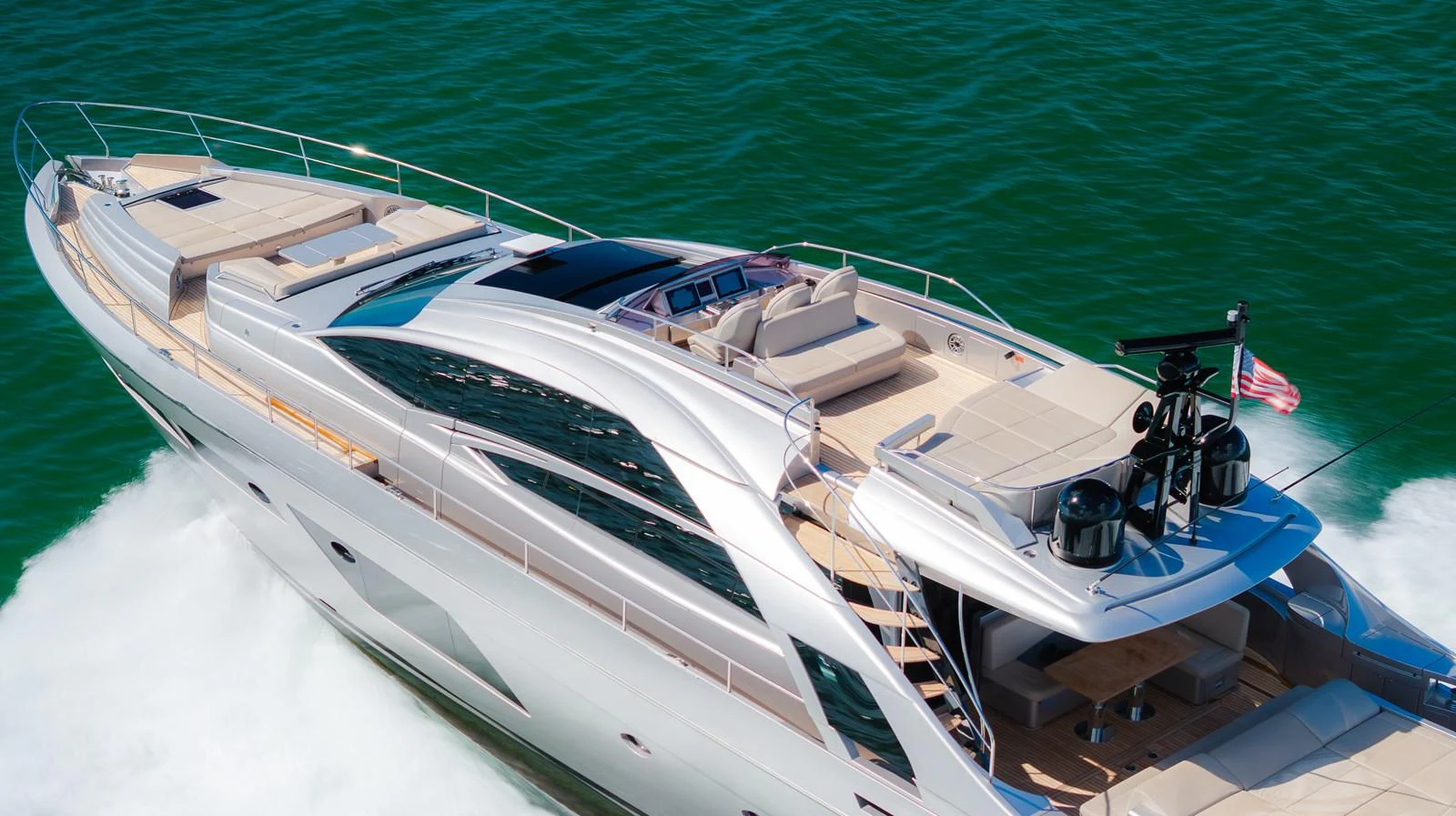 A sleek and modern yacht glides effortlessly through the water, showcasing its elegant design and spacious deck areas. aboard NOVA Yacht for Sale