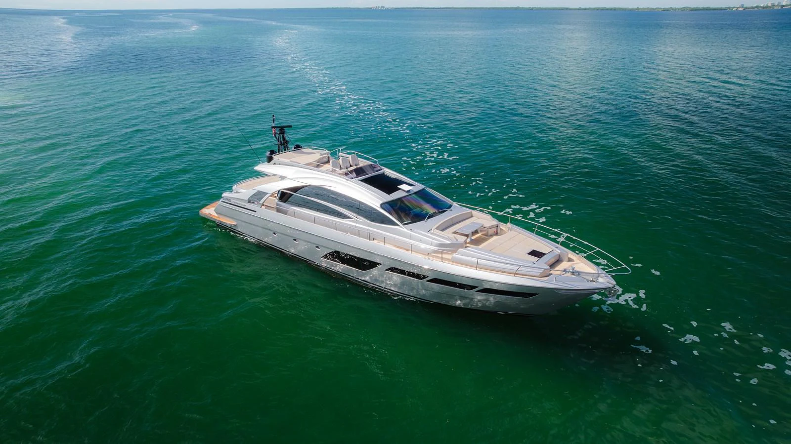 A sleek and modern yacht glides gracefully over calm, clear waters. aboard NOVA Yacht for Sale