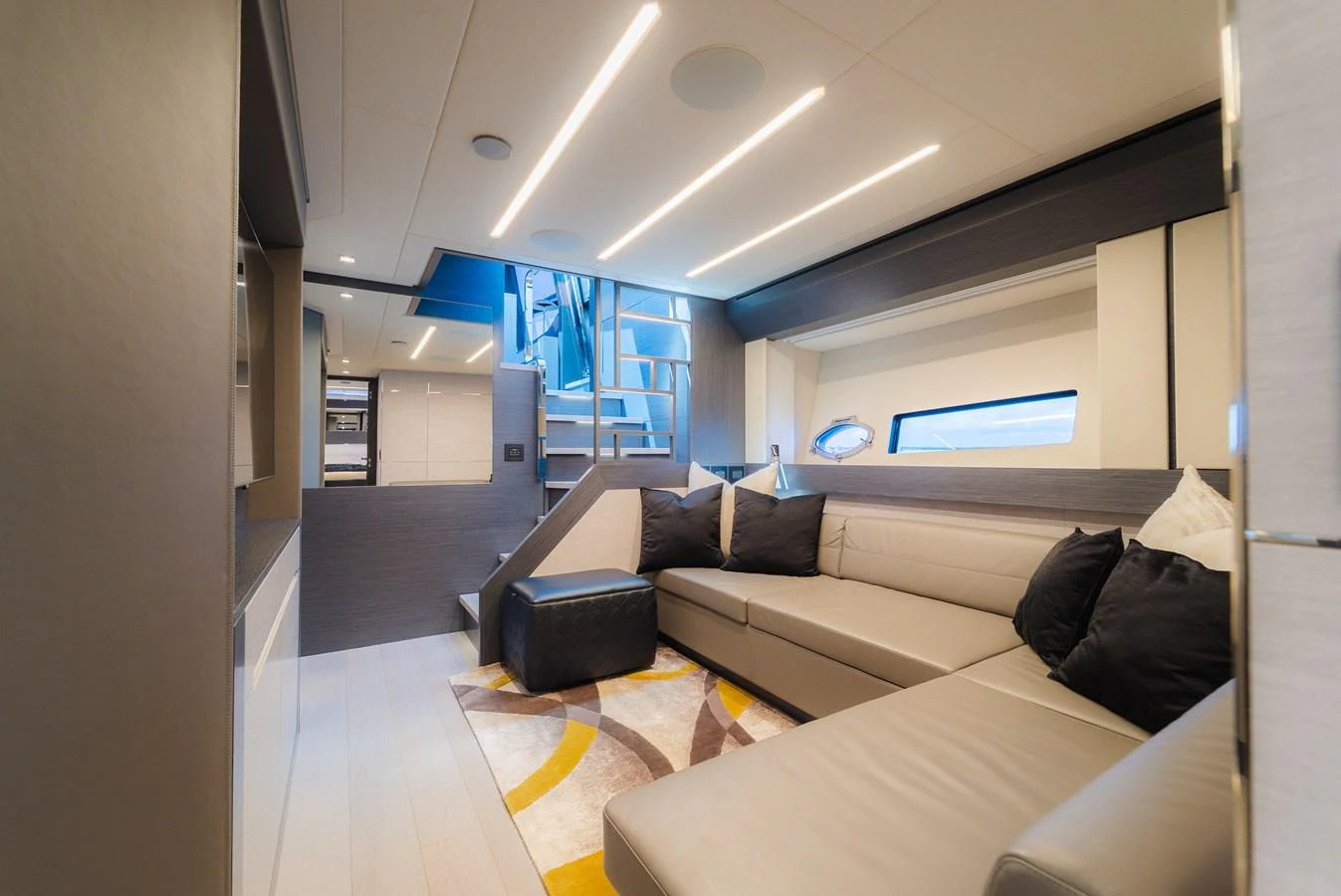 The salon features a modern and comfortable seating area with stylish lighting and a staircase leading to the upper deck. aboard NOVA Yacht for Sale