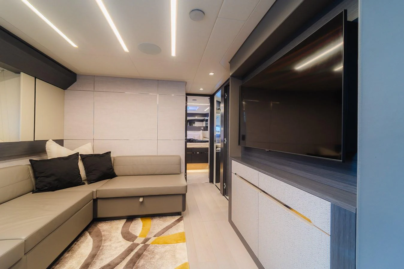 The yacht's salon features a modern design with a comfortable seating area and a large flat-screen TV. aboard NOVA Yacht for Sale