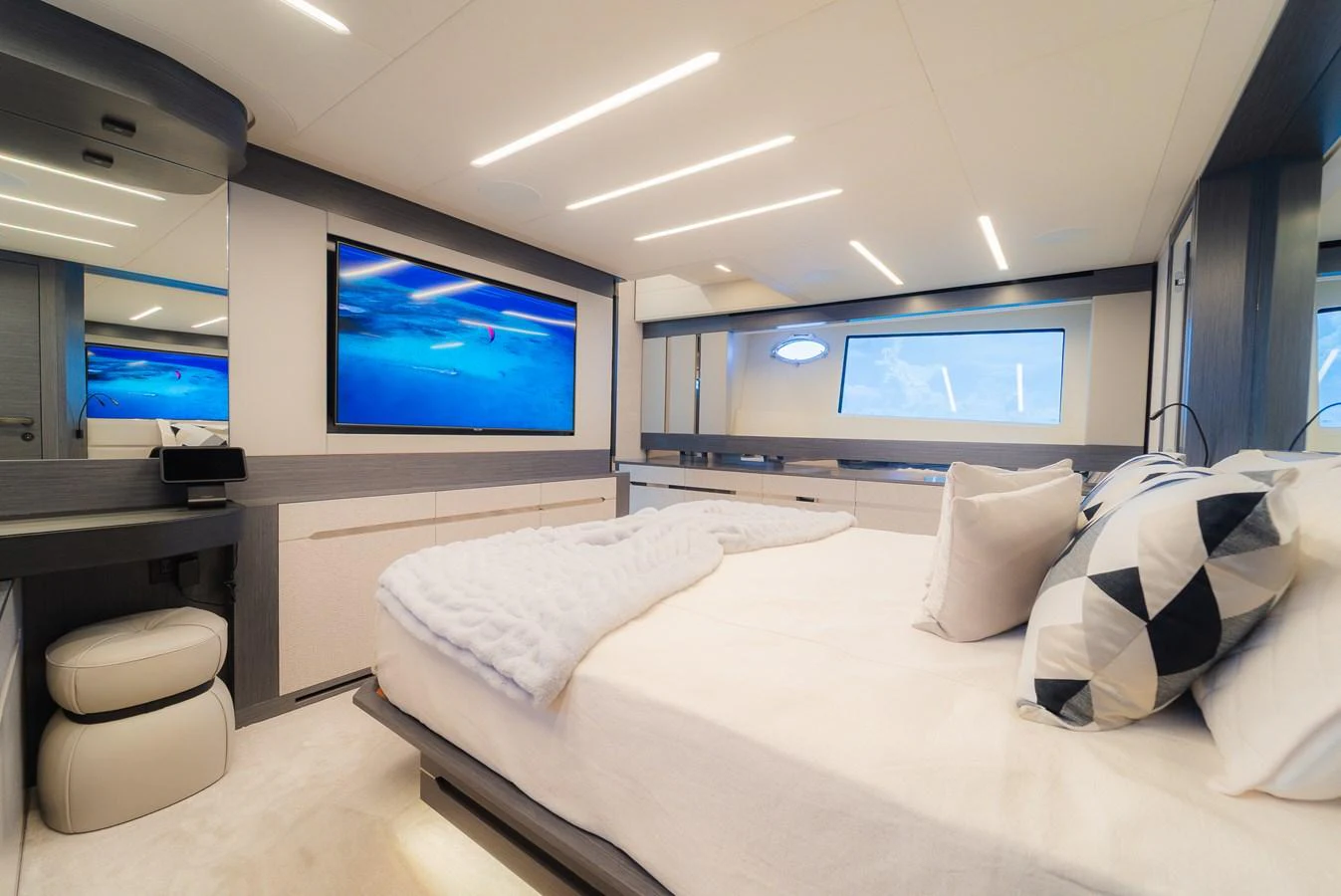 The stateroom features a luxurious bed with modern decor and ample natural light. aboard NOVA Yacht for Sale