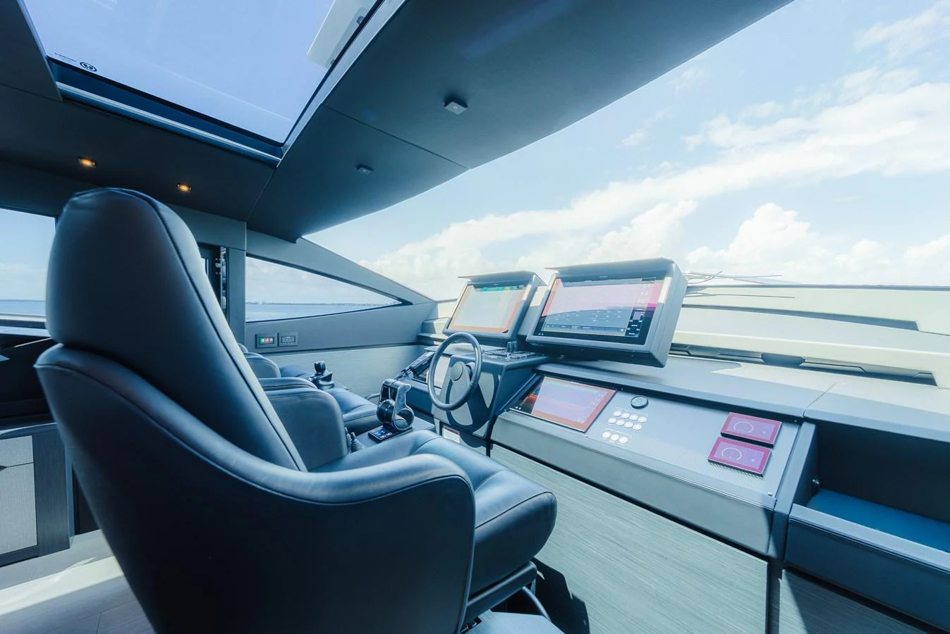 The helm station features advanced navigation equipment and luxurious seating, offering a commanding view of the surroundings. aboard NOVA Yacht for Sale