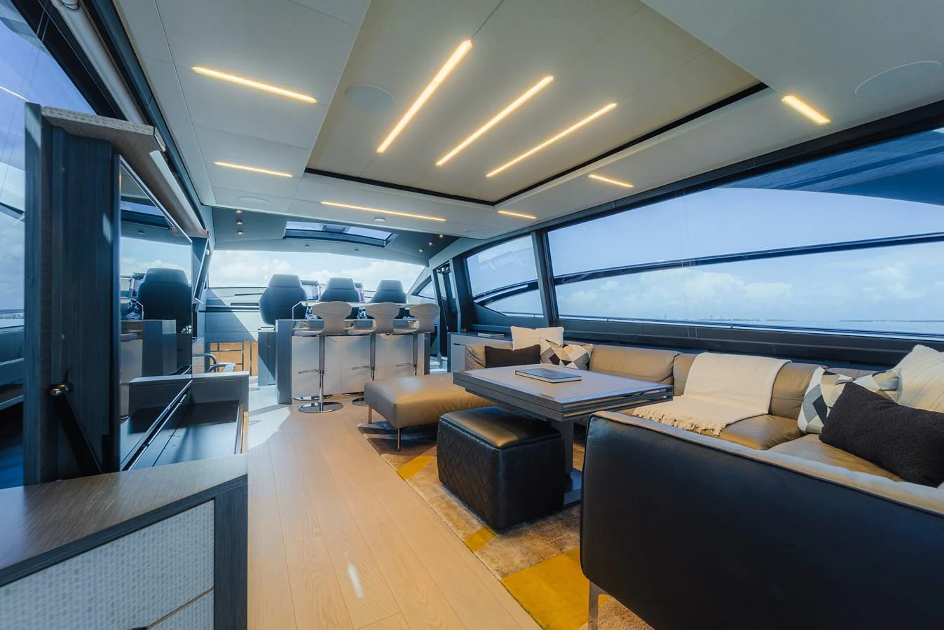 The salon offers a spacious and modern seating area with panoramic windows and contemporary furnishings. aboard NOVA Yacht for Sale