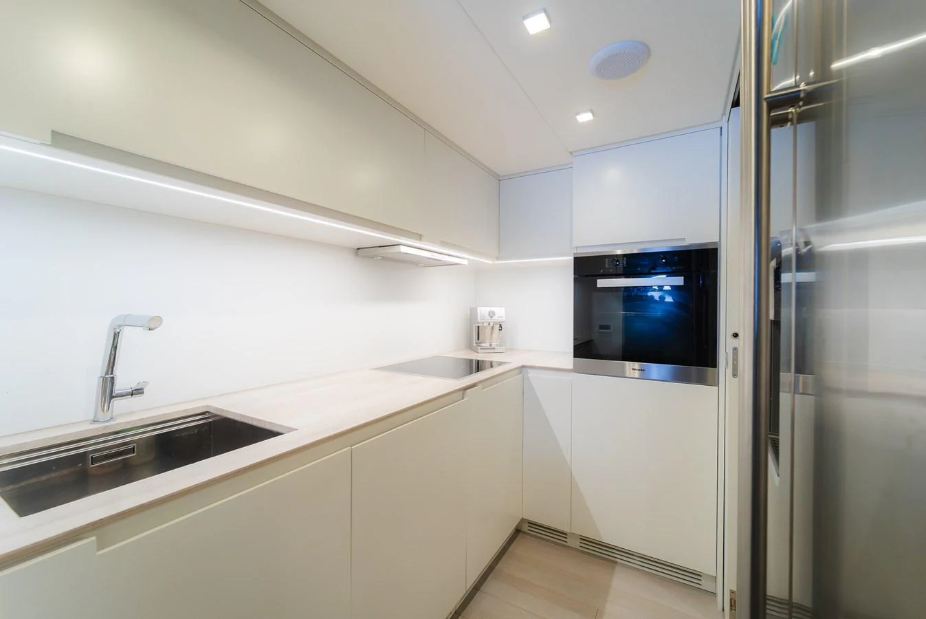 The yacht's galley is sleek and modern, featuring high-end appliances and ample counter space. aboard NOVA Yacht for Sale