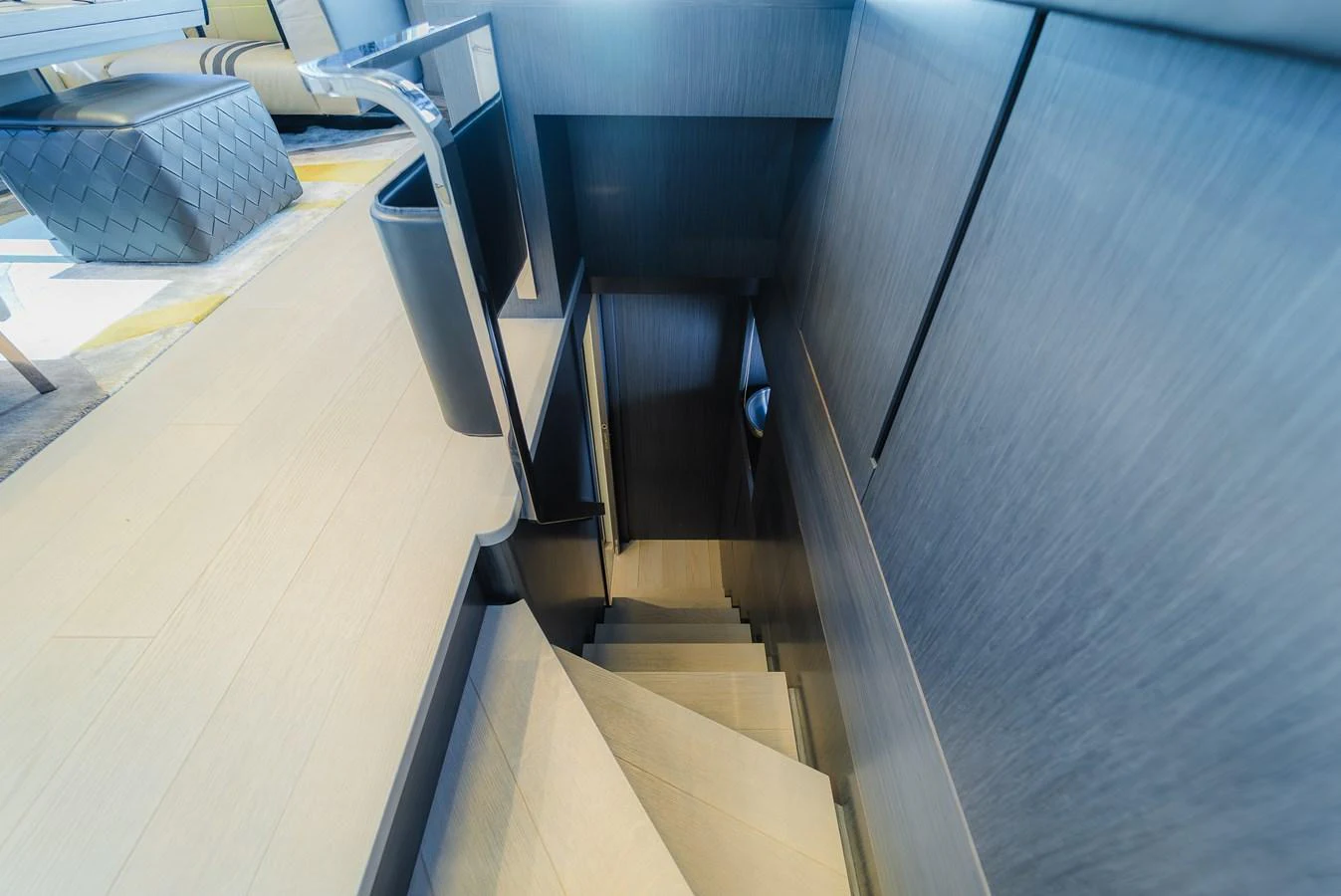 A modern staircase with sleek design elements leads to the lower deck. aboard NOVA Yacht for Sale