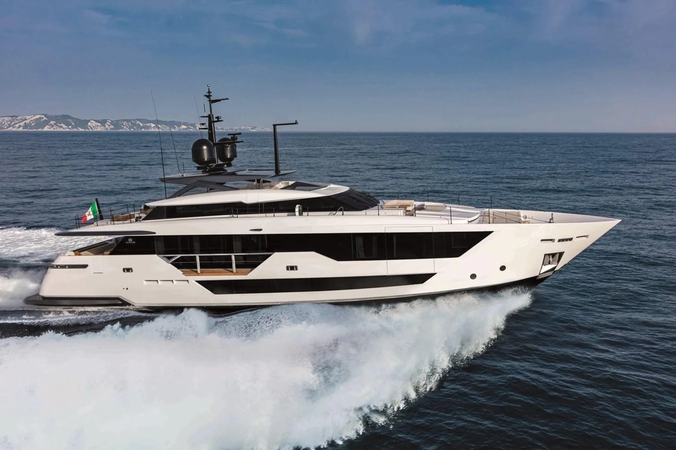 A sleek and modern yacht cruising on the open sea. aboard CUSTOM LINE SAETTA 128/02 Yacht for Sale