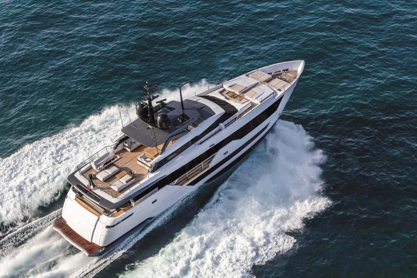 A sleek and modern yacht cruises swiftly through the open sea, showcasing its elegant design and spacious deck areas. aboard CUSTOM LINE SAETTA 128/02 Yacht for Sale