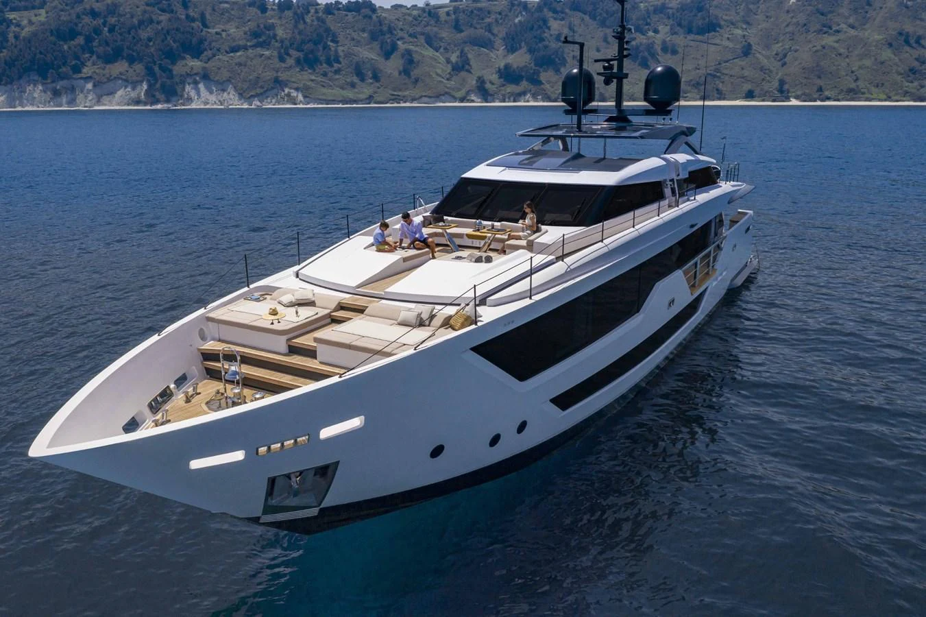 A sleek and modern yacht cruising on calm waters with a scenic coastline in the background. aboard CUSTOM LINE SAETTA 128/02 Yacht for Sale