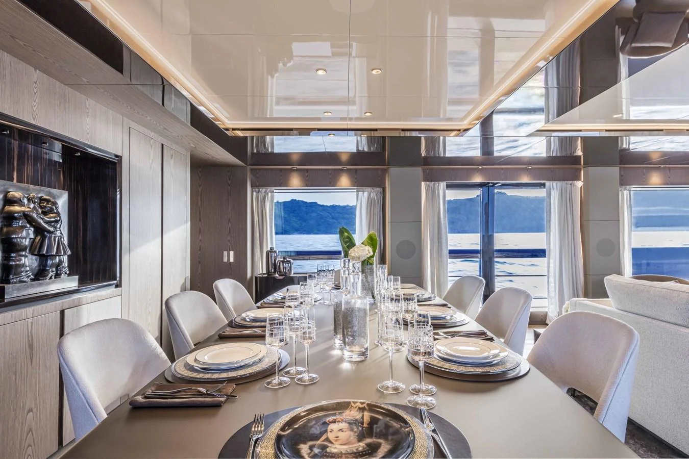 The yacht's dining area features a sophisticated table setting with panoramic views of the sea. aboard CUSTOM LINE SAETTA 128/02 Yacht for Sale