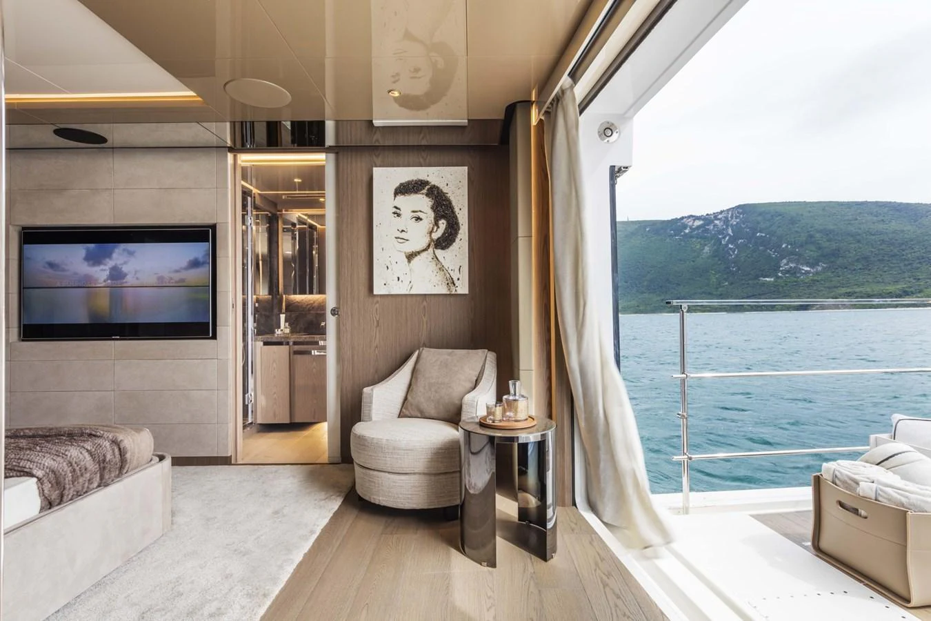 A luxurious stateroom with a serene view of the sea through large windows. aboard CUSTOM LINE SAETTA 128/02 Yacht for Sale