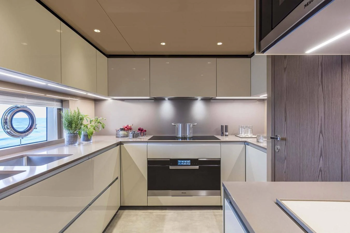The yacht's galley features modern appliances and sleek cabinetry, creating a stylish and functional cooking space. aboard CUSTOM LINE SAETTA 128/02 Yacht for Sale