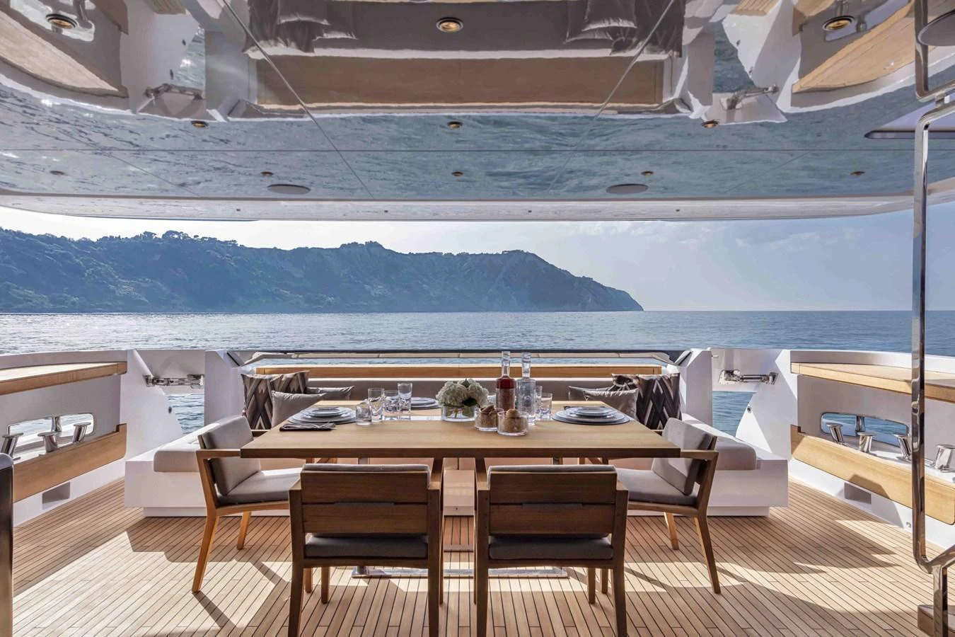 The aft deck features an elegant dining area with stunning ocean views. aboard CUSTOM LINE SAETTA 128/02 Yacht for Sale