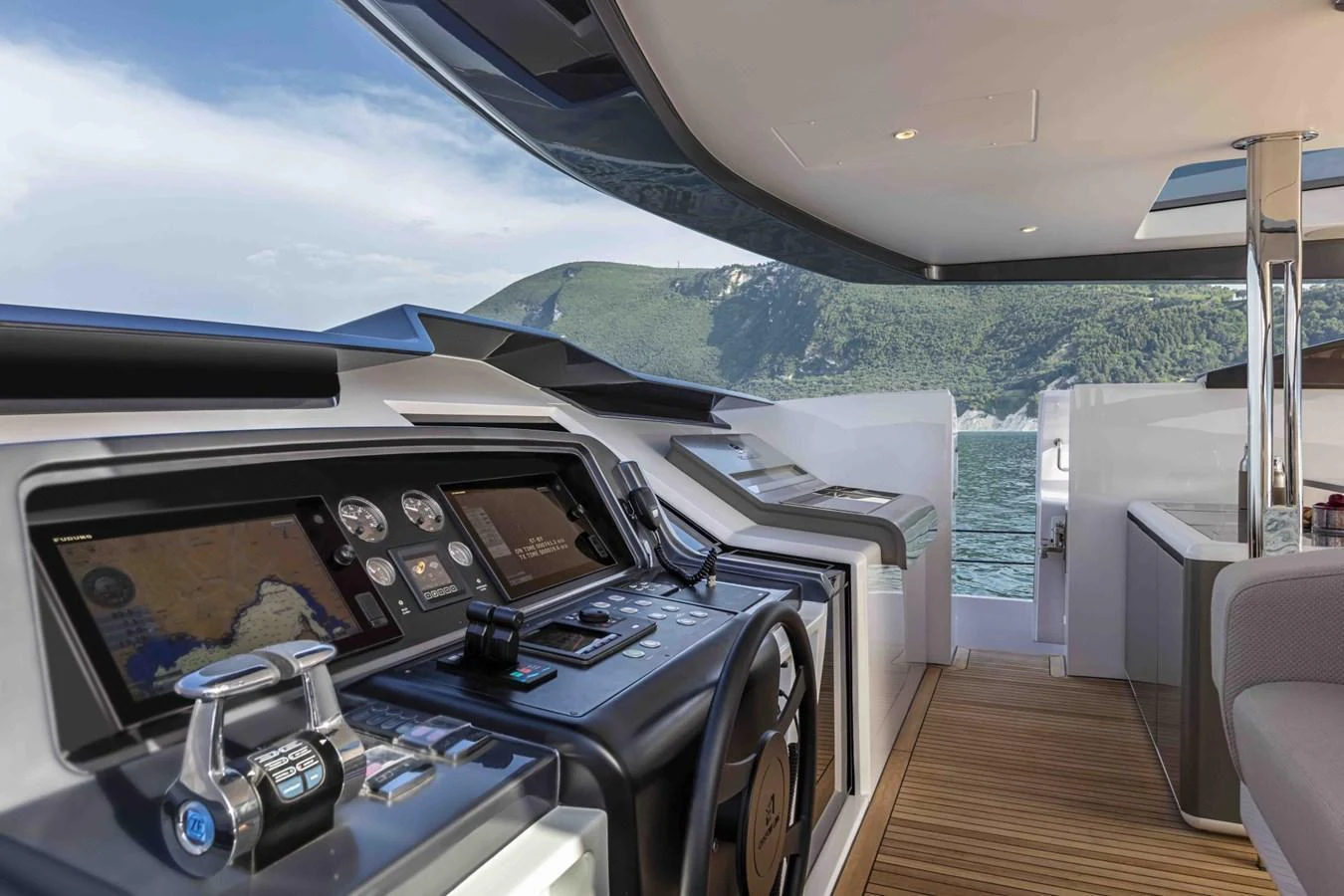 The helm station offers a sleek and modern command center with advanced navigation equipment and panoramic views. aboard CUSTOM LINE SAETTA 128/02 Yacht for Sale