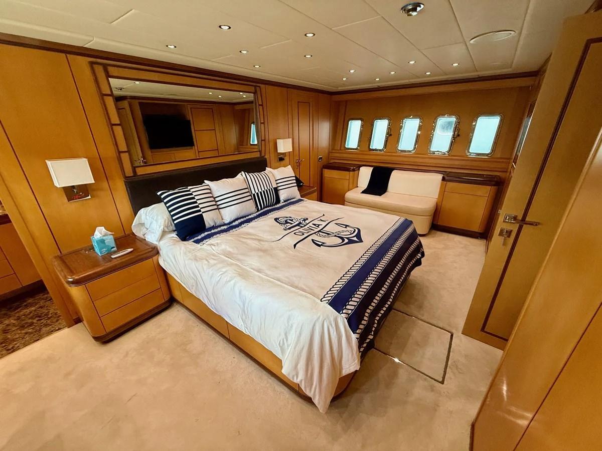 a bedroom with a bed and a desk aboard OLIVIA K Yacht for Sale
