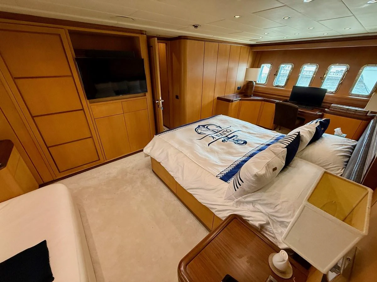 a room with a bed and a tv aboard OLIVIA K Yacht for Sale