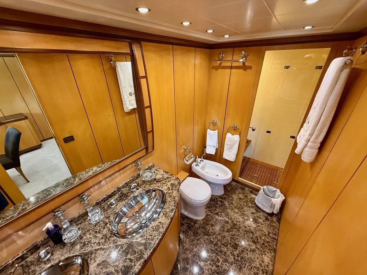 a bathroom with marble counter tops aboard OLIVIA K Yacht for Sale