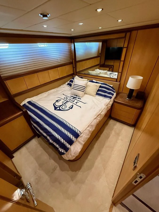 a bed with a blue and white checkered blanket aboard OLIVIA K Yacht for Sale