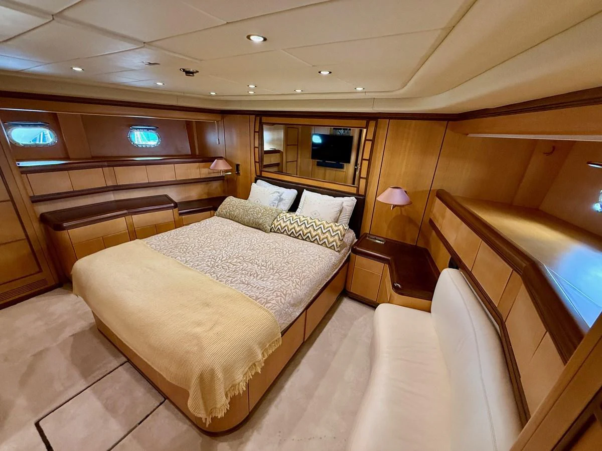 a room with a bed and a desk aboard OLIVIA K Yacht for Sale