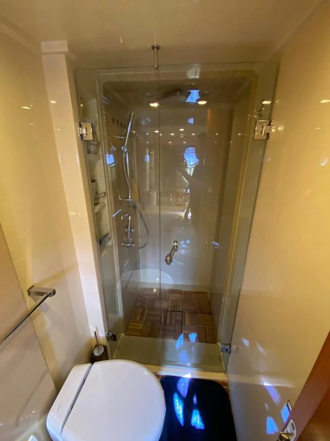 a bathroom with a glass shower aboard DREN Yacht for Sale