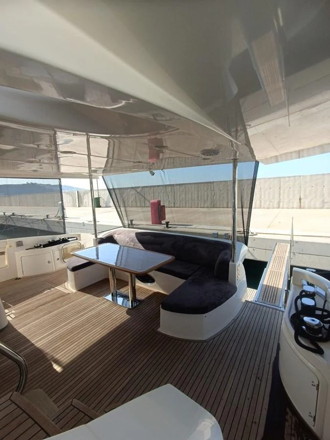 a room with a bed and a table aboard DREN Yacht for Sale