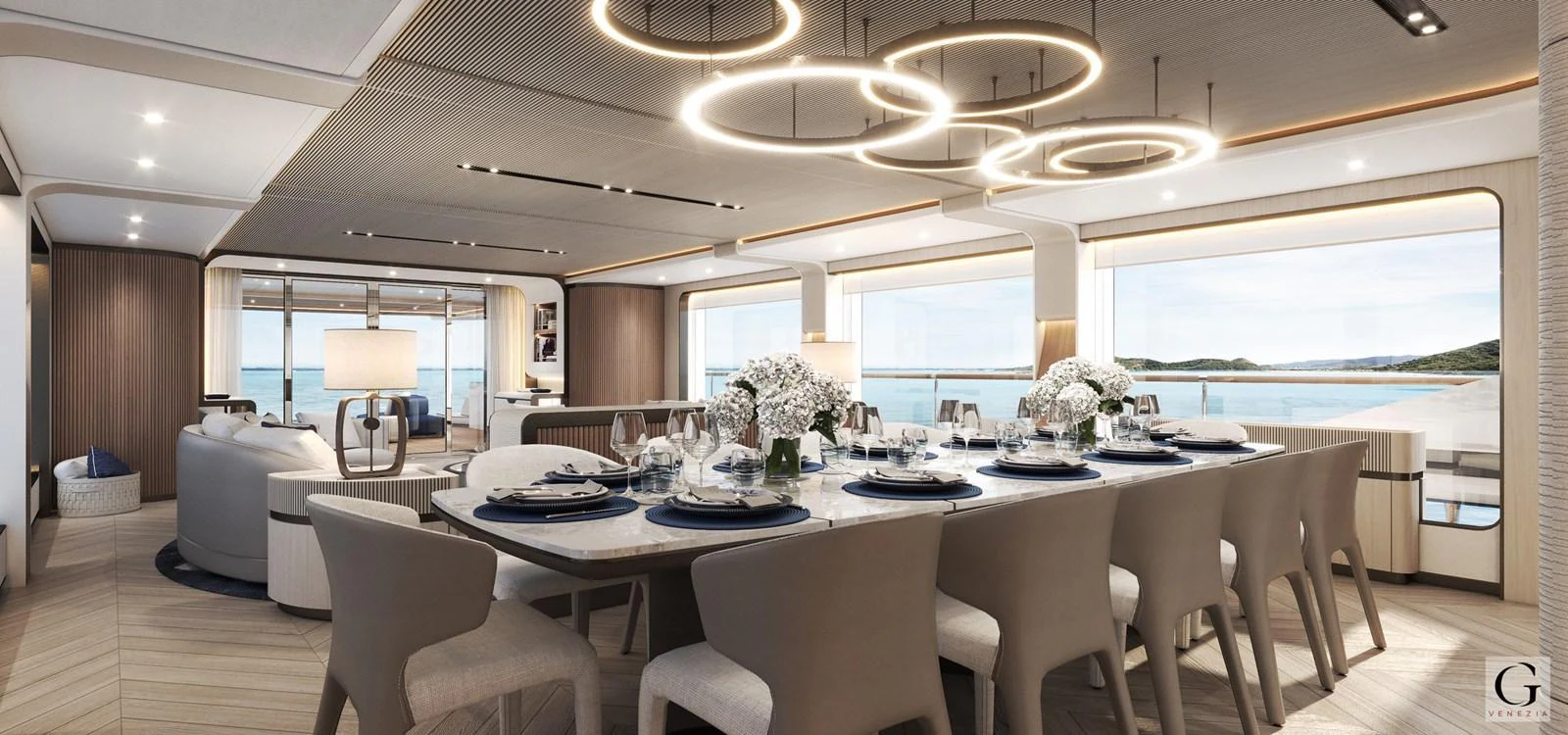 The yacht's dining area features elegant table settings and modern lighting with panoramic ocean views. aboard MAJESTY 145 Yacht for Sale