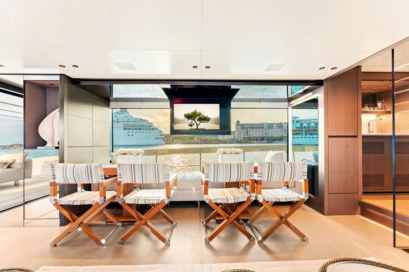 a room with tables and chairs aboard NORTH Yacht for Sale