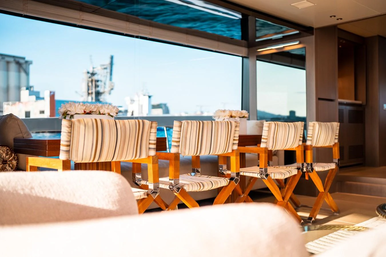 a room with chairs and a large window aboard NORTH Yacht for Sale