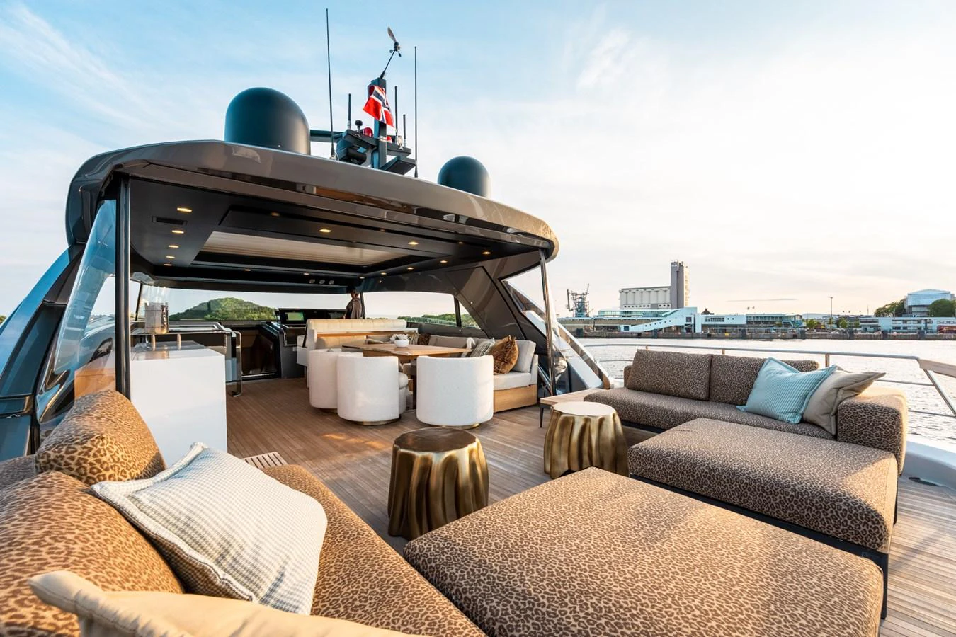 a deck with a couch and a table and chairs aboard NORTH Yacht for Sale