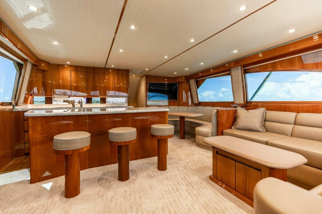 a large living room with a large kitchen and a bar aboard MISS VIRGINIA Yacht for Sale