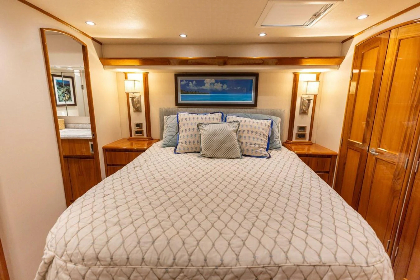 a bed with a white comforter aboard MISS VIRGINIA Yacht for Sale