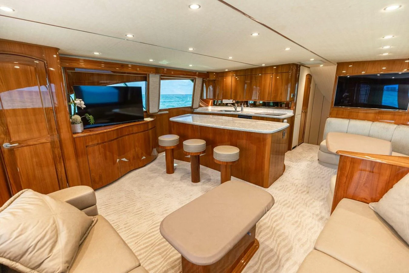 a living room with a kitchen and a bar aboard MISS VIRGINIA Yacht for Sale