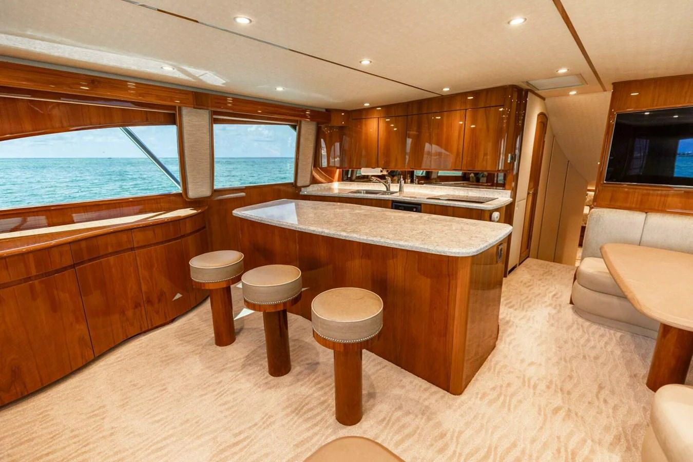 a large kitchen with a bar and bar stools aboard MISS VIRGINIA Yacht for Sale