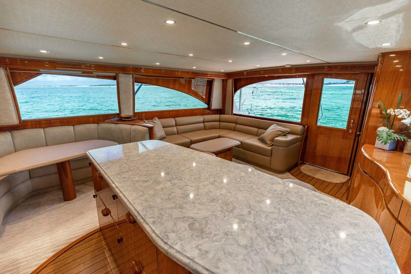 a living room with a large table aboard MISS VIRGINIA Yacht for Sale