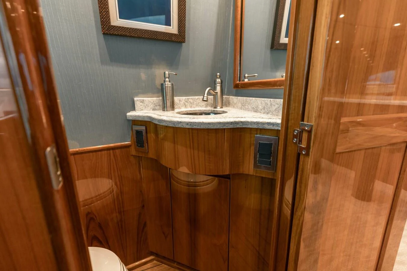 a bathroom with a sink and wooden cabinets aboard MISS VIRGINIA Yacht for Sale