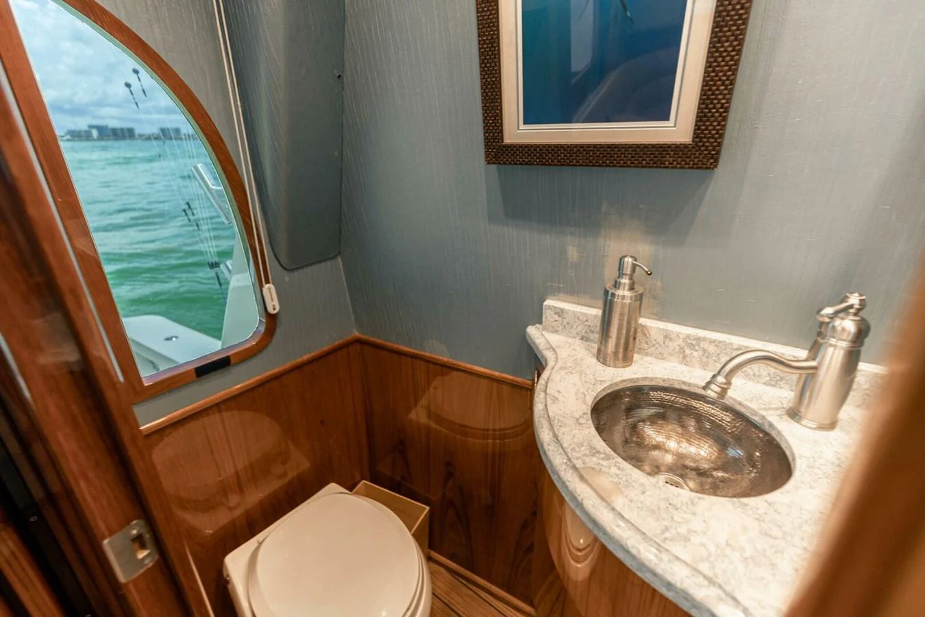 a bathroom with a sink and a toilet aboard MISS VIRGINIA Yacht for Sale