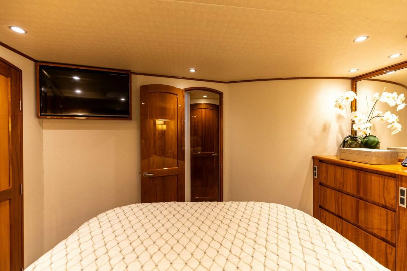 a hotel room with a bed and tv aboard MISS VIRGINIA Yacht for Sale