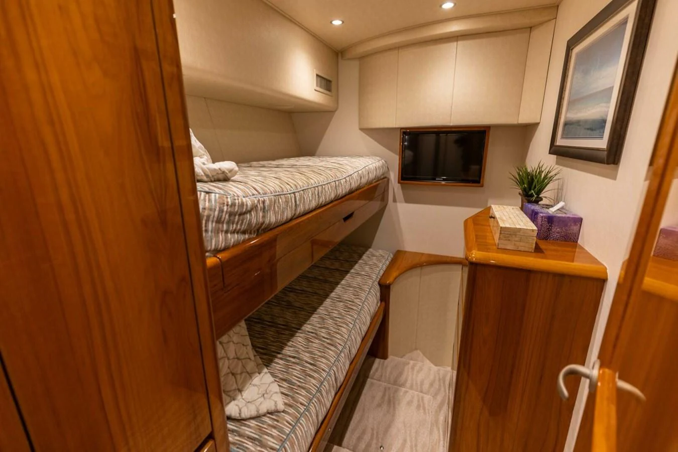a small bedroom with a bed aboard MISS VIRGINIA Yacht for Sale