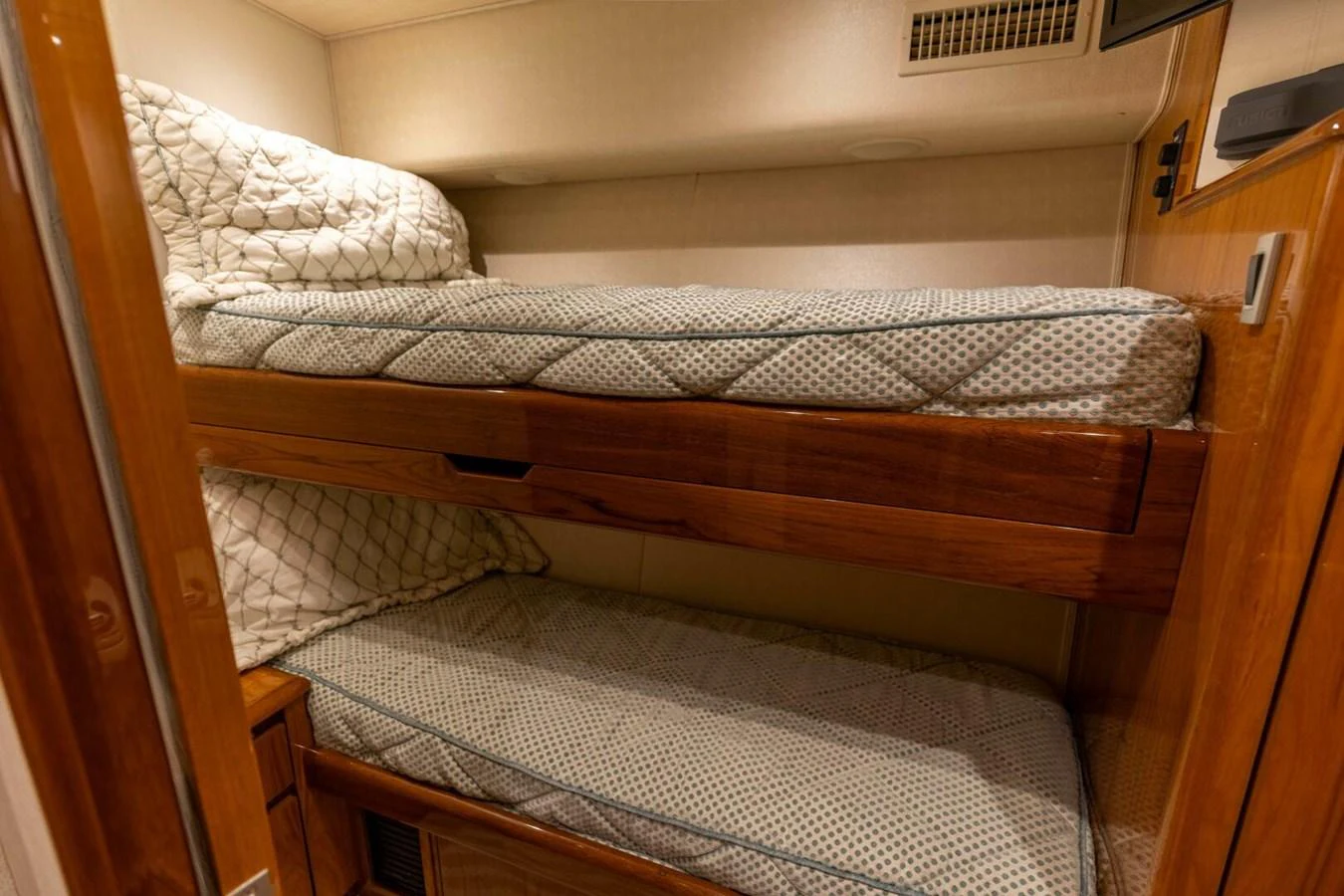 a bed with a wood frame aboard MISS VIRGINIA Yacht for Sale