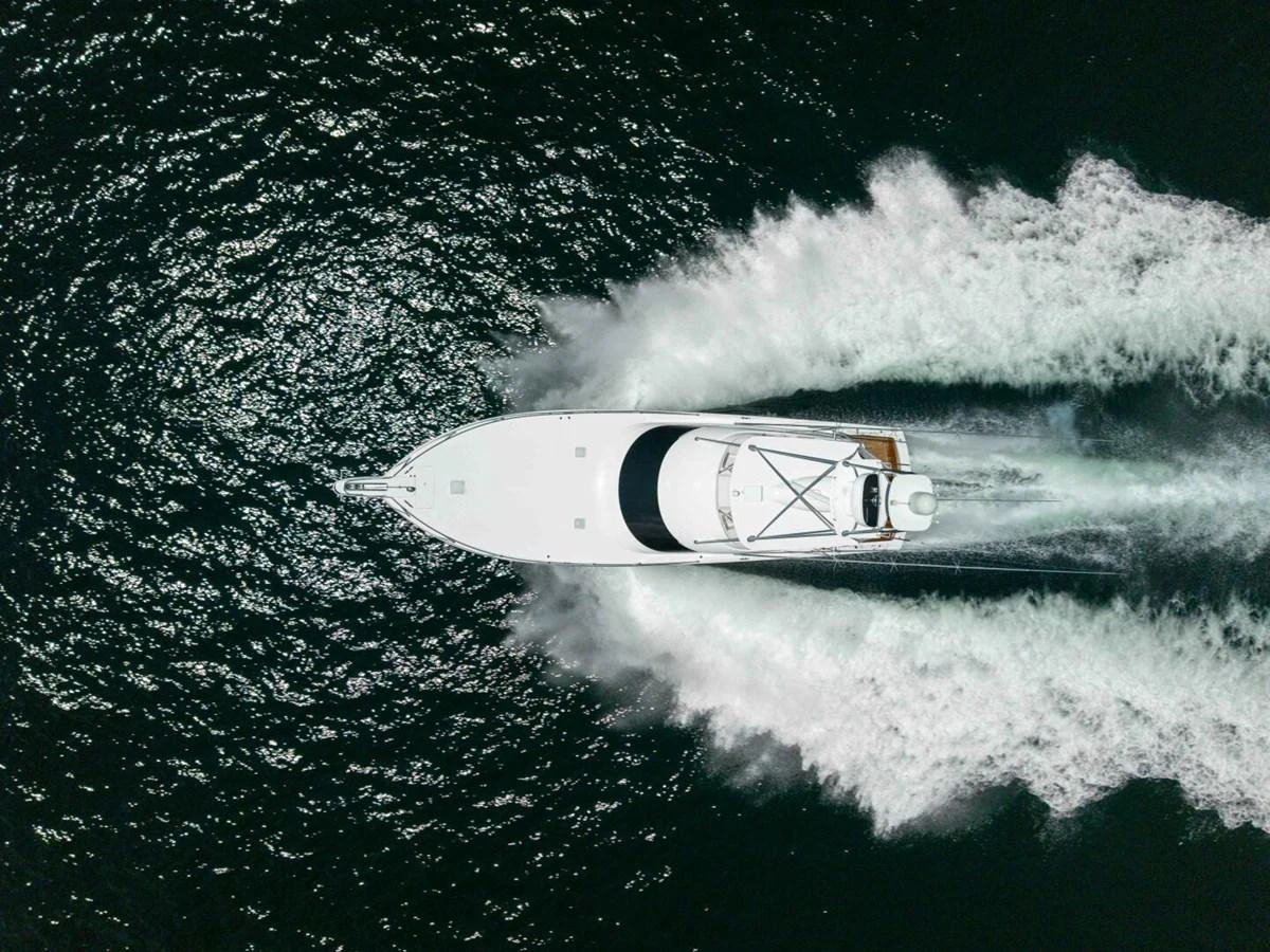 a white surfboard in the ocean aboard MISS VIRGINIA Yacht for Sale