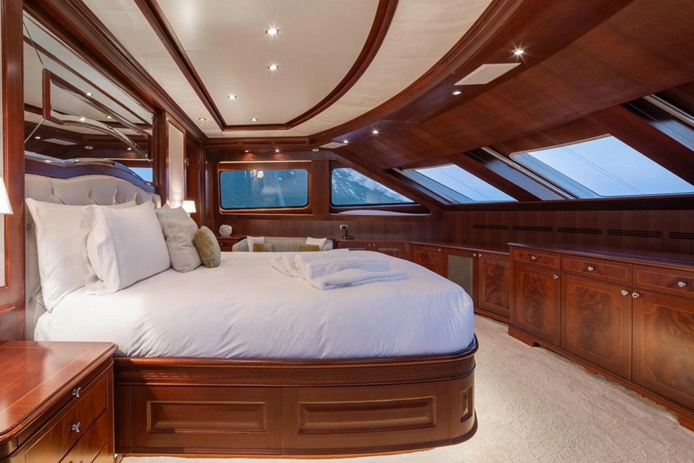 The master stateroom features luxurious wood paneling and large windows for natural light. aboard VIRTUE Yacht for Sale
