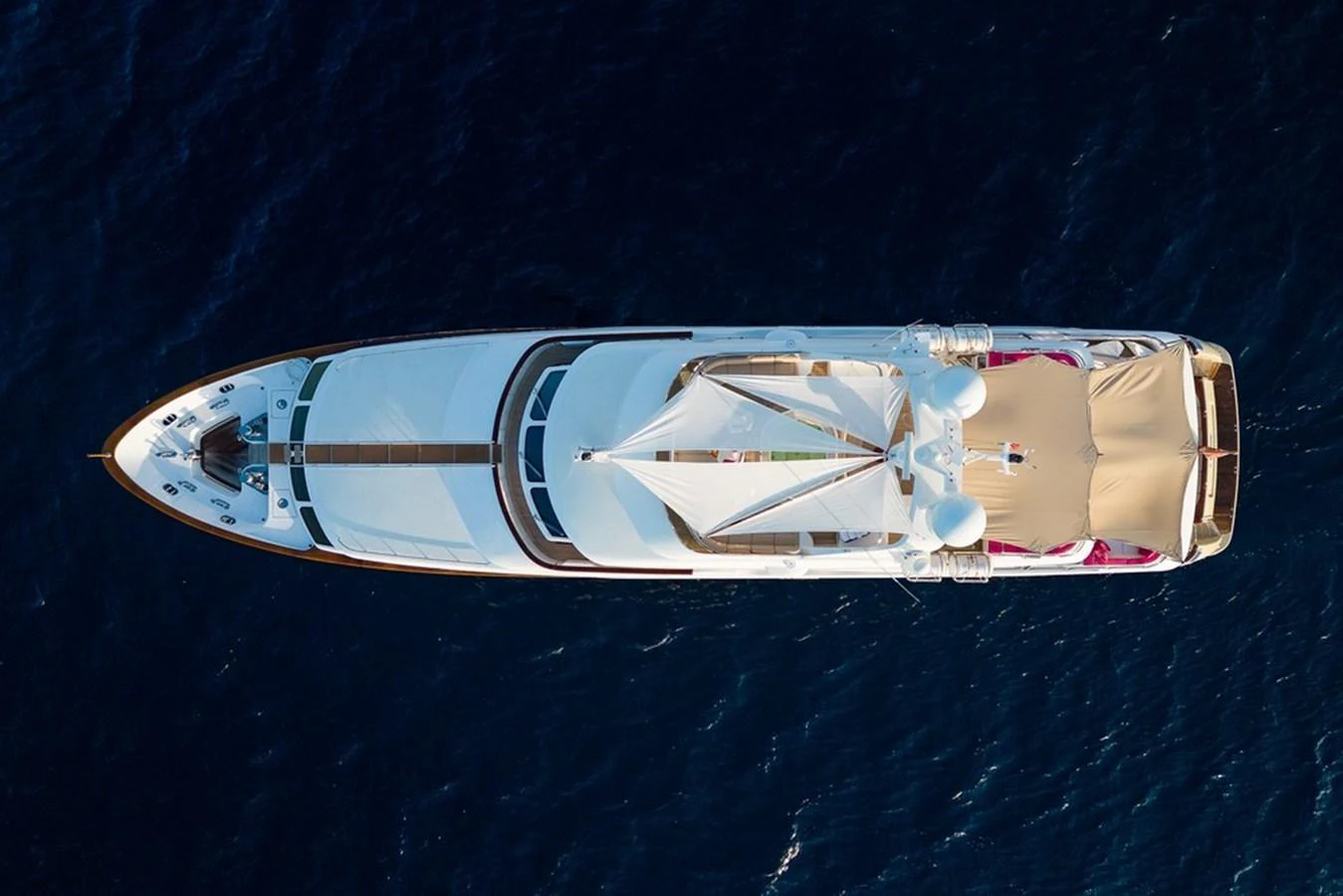 An aerial view of a luxurious yacht cruising through deep blue waters. aboard VIRTUE Yacht for Sale