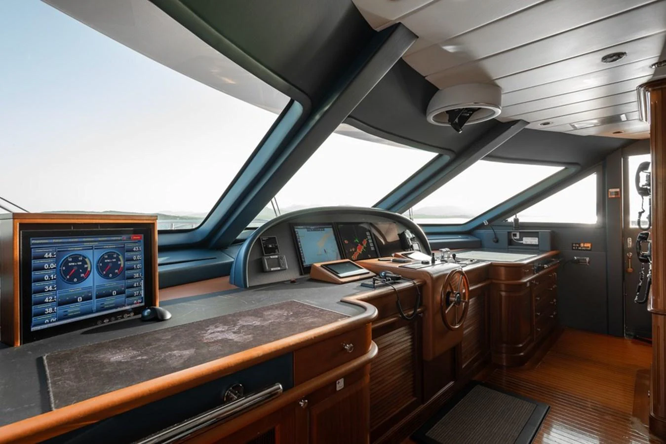 The helm features state-of-the-art navigation equipment and luxurious wood finishes. aboard VIRTUE Yacht for Sale