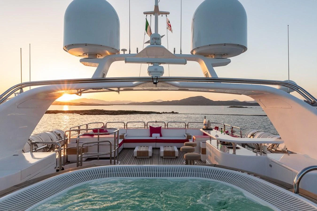 The sundeck features a luxurious jacuzzi with ample seating and stunning sunset views. aboard VIRTUE Yacht for Sale