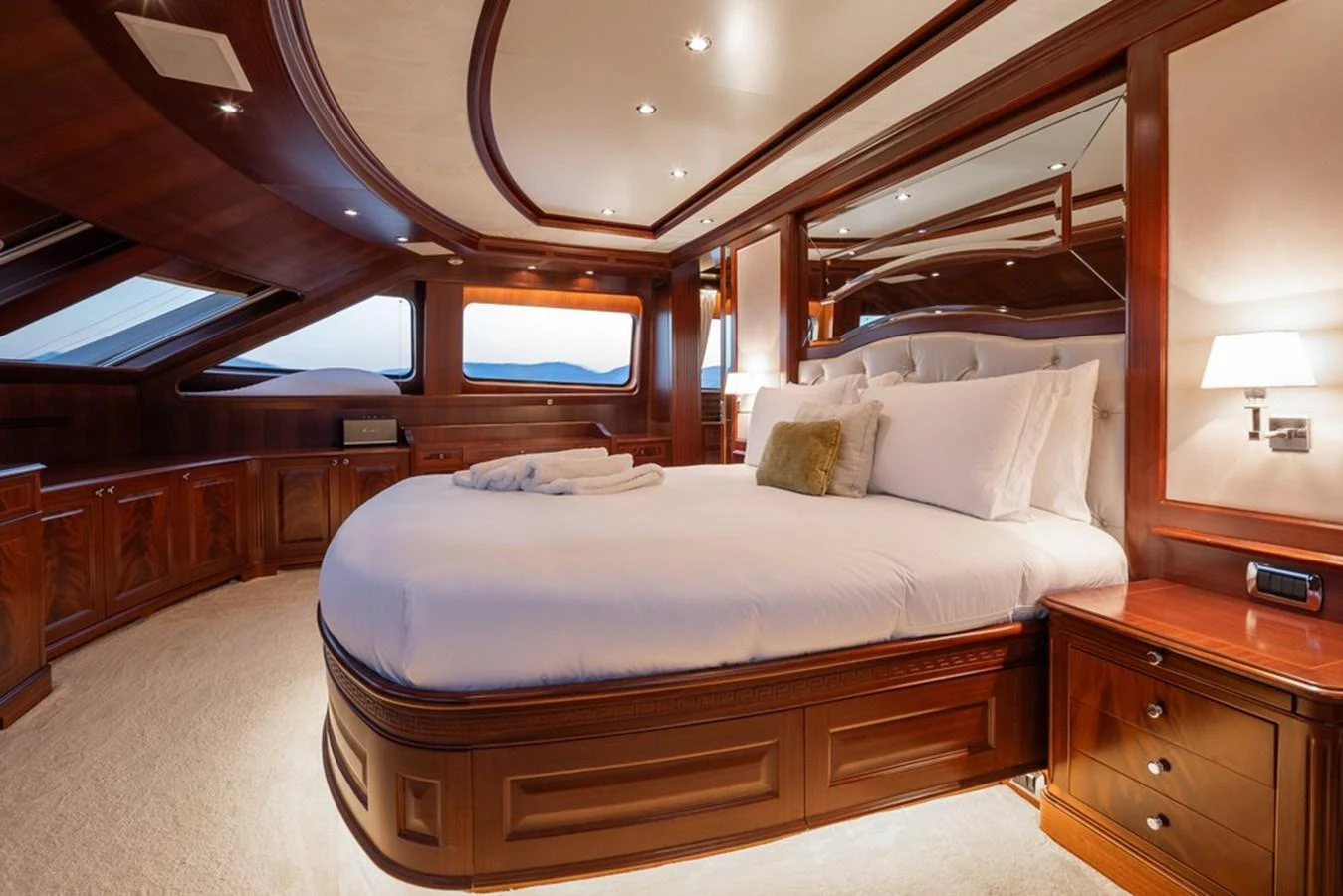 The master stateroom features luxurious wood paneling and a large, comfortable bed with plush bedding. aboard VIRTUE Yacht for Sale