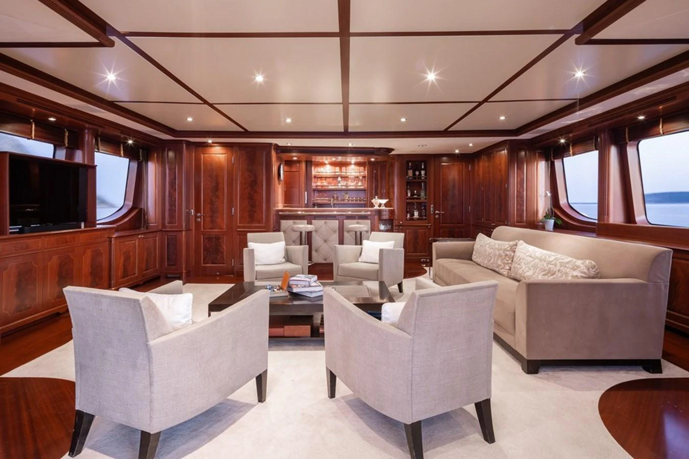 The yacht's salon features elegant wood paneling, plush seating, and a sophisticated ambiance. aboard VIRTUE Yacht for Sale