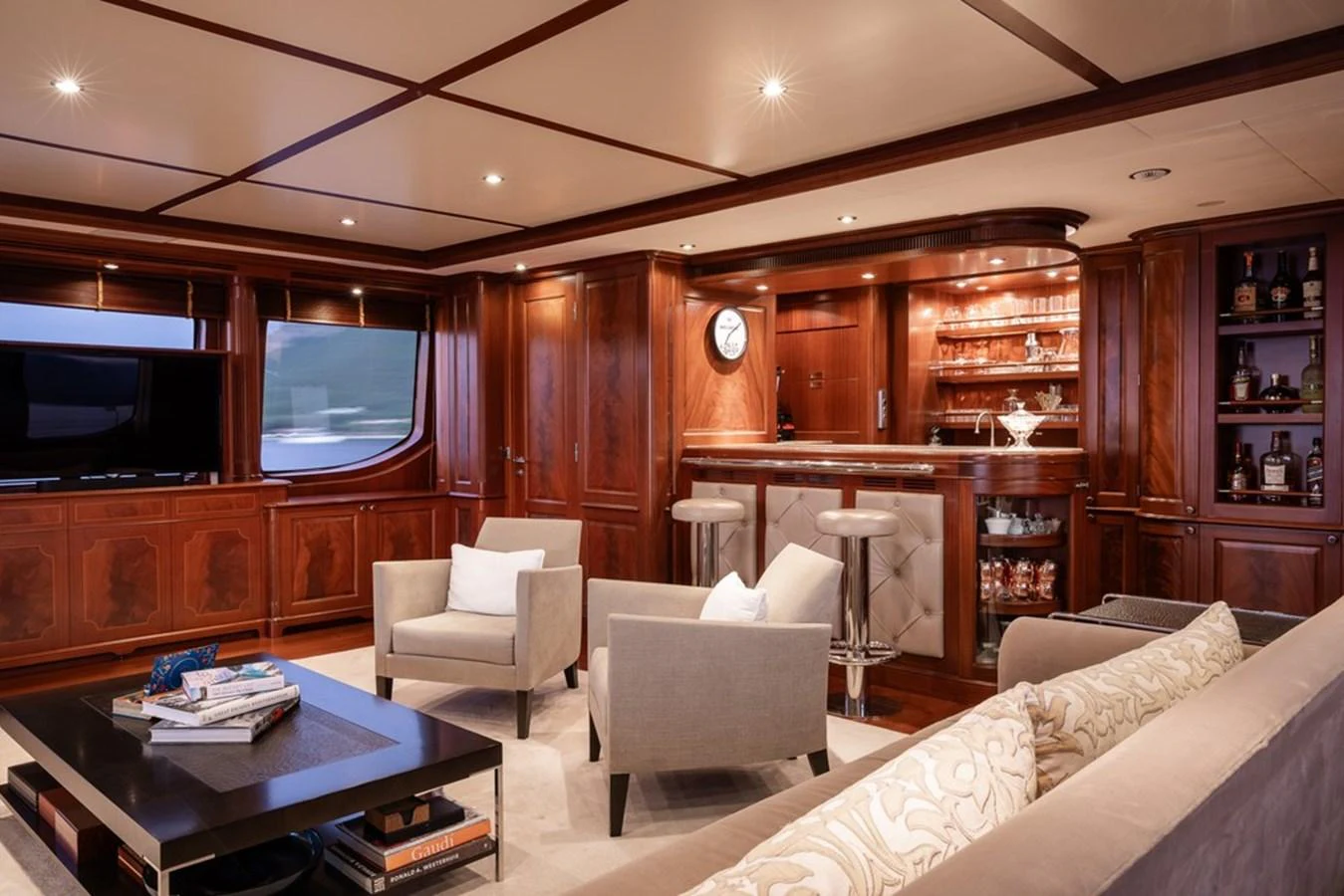 The yacht's salon features elegant wood paneling, a well-stocked bar, and comfortable seating for relaxation. aboard VIRTUE Yacht for Sale