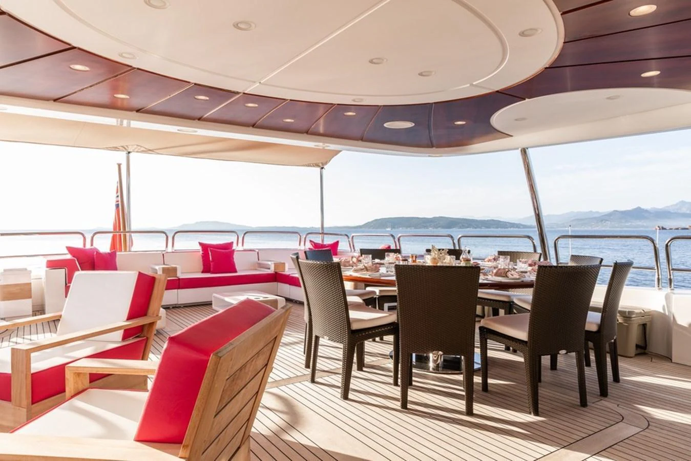 The aft deck features a spacious dining area with comfortable seating and stunning ocean views. aboard VIRTUE Yacht for Sale